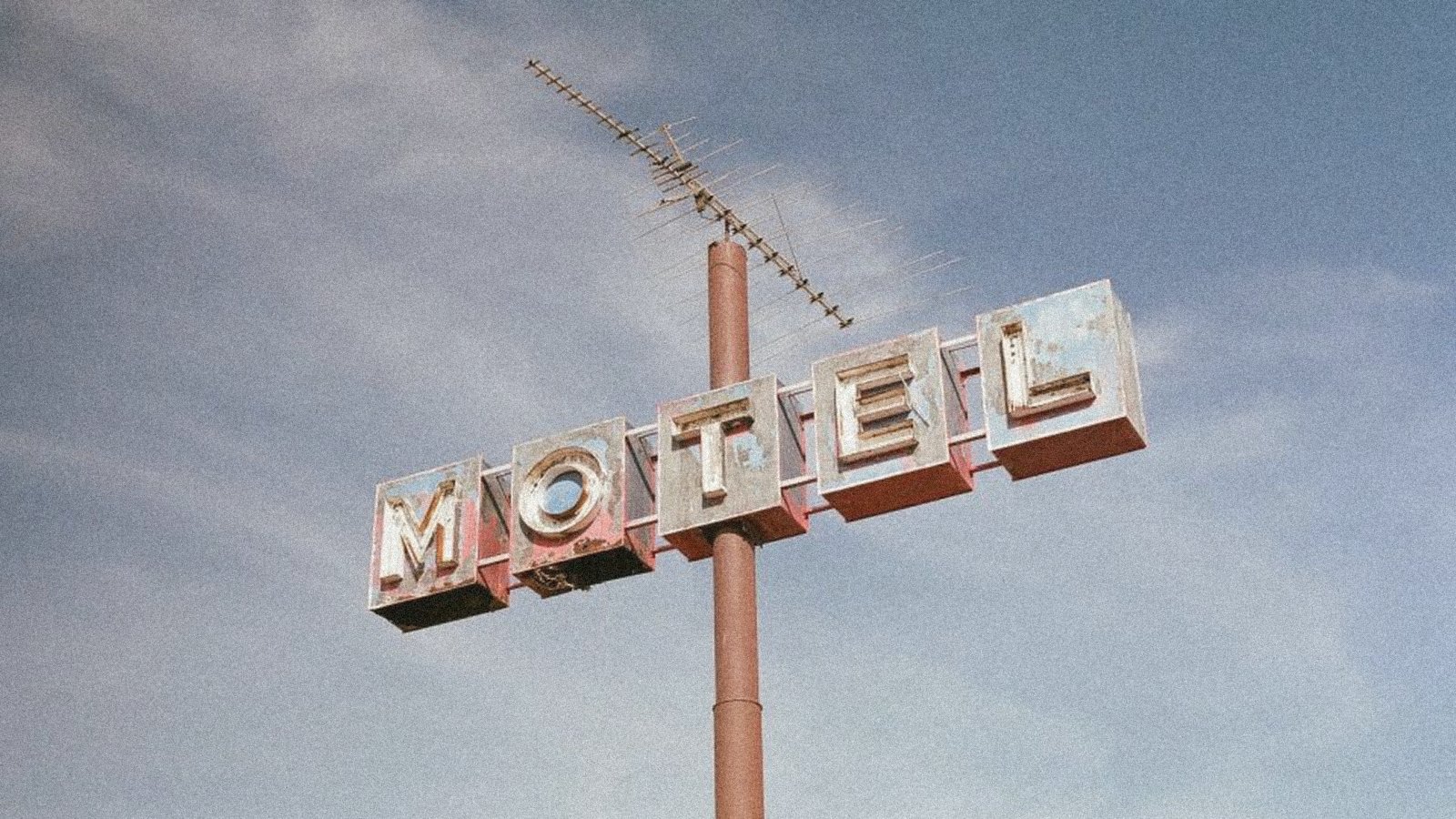 A motel sign against an open sky