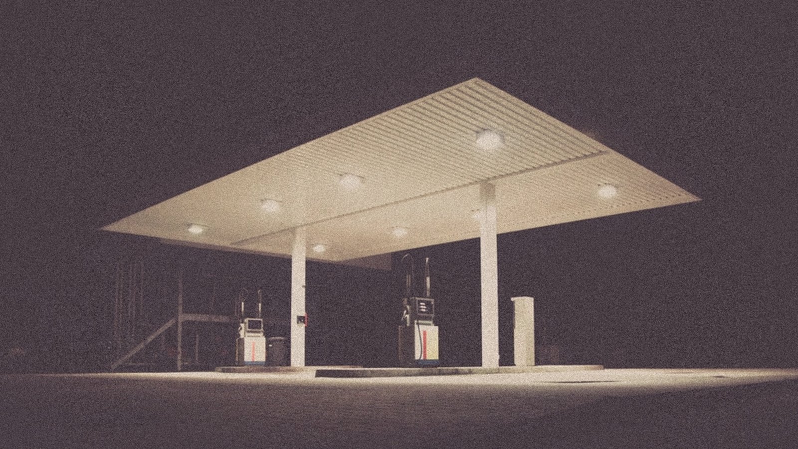 A petrol station canopy lit at dusk