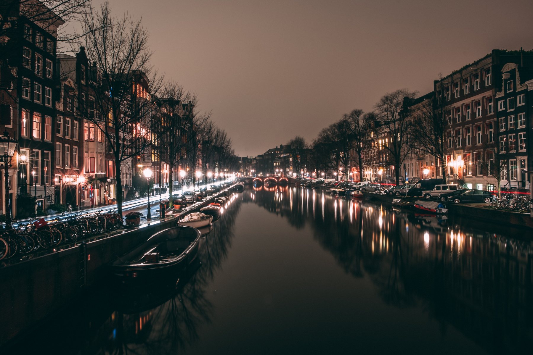 Amsterdam canal at night with warm lights