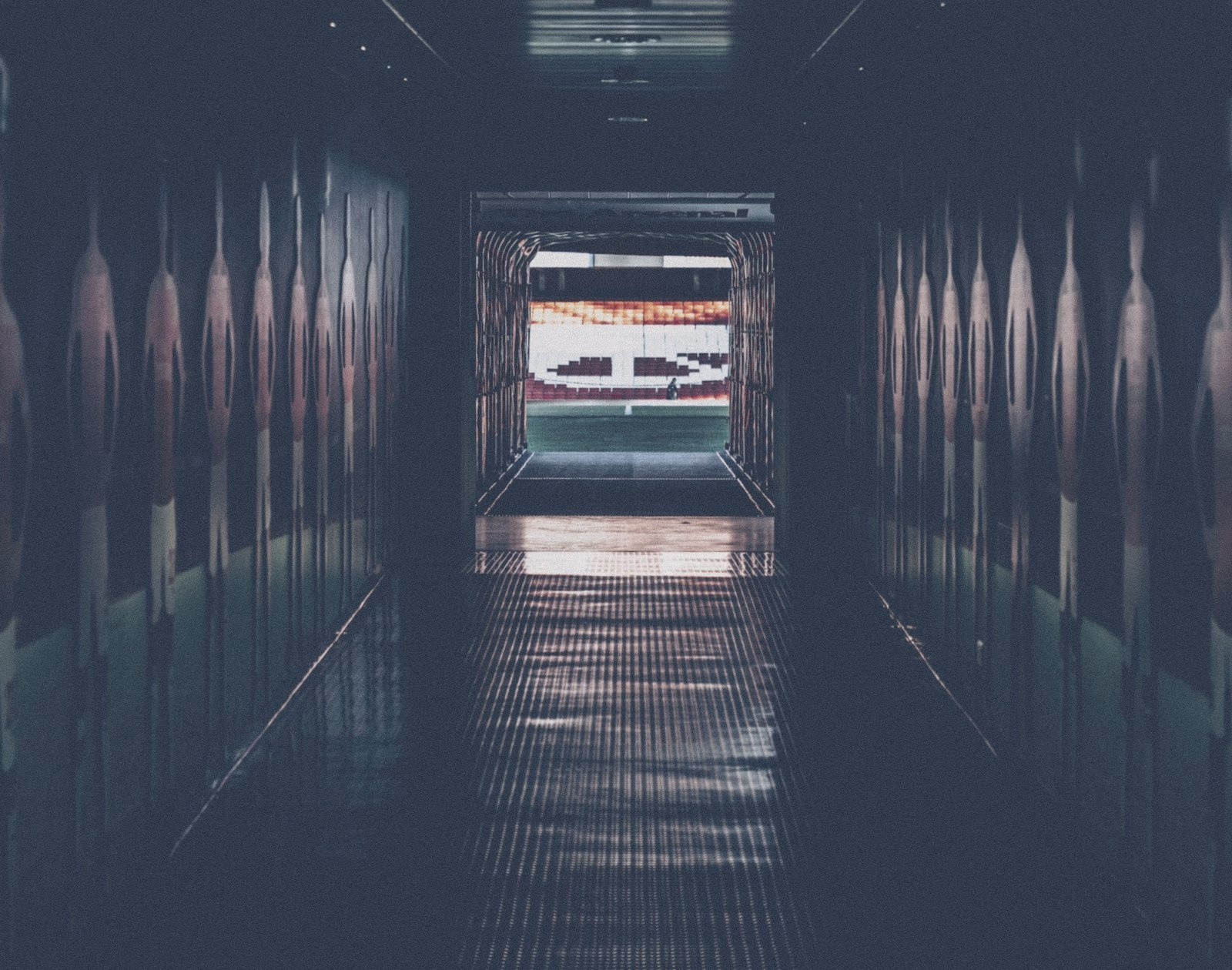 A stadium players’ tunnel looking out to the pitch